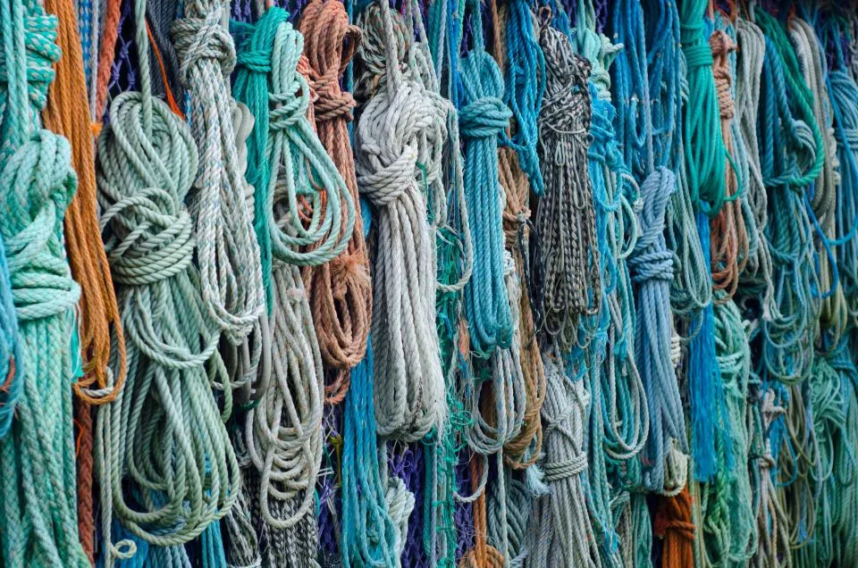 Coils of natural and dyed rope hanging side by side